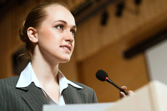 female speaking into a microphone