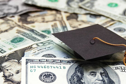 Graduation cap on top of American paper currency